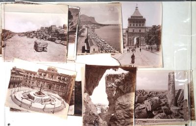 many old photos of a city on the wall