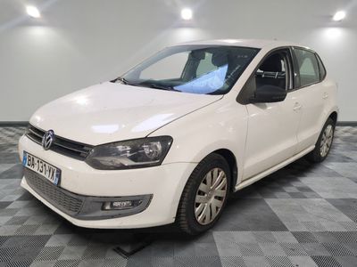 la volkswagen polo blanche est garée dans une pièce au sol à carreaux