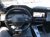 someone is sitting in the driver ' s seat of a car with their feet on the steering wheel