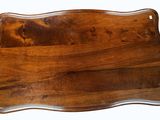 a wooden cutting board with a handle on a white background