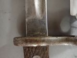 a close up of a knife on a metal pole