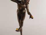 an image of a bronze statue of a woman holding an apple