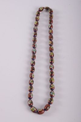 a multicolored beaded necklace on a white background