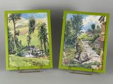 pair of paintings of a stream and a house in a green frame