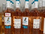 several bottles of wine are lined up on a shelf
