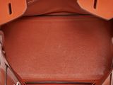 the inside of a brown leather bag with two handles