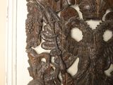 a wooden carving on the wall of a room