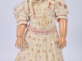 an old fashioned doll with a bonnet and dress on a white background