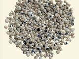 an image of a pile of white beads with blue eyes on them