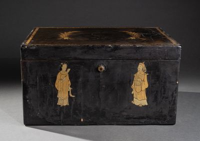 an old black box with gold decorations on the sides of it