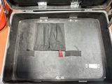 a black suitcase with a red handle sitting on a table