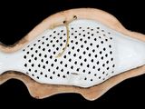 a white fish shaped dish with holes on it