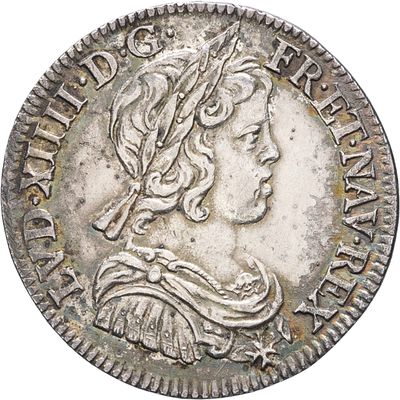a silver coin with a woman ' s head on it