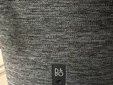 a close up of the back of a speaker on a wooden table