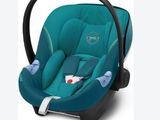 a close up of a baby car seat with a handlebar