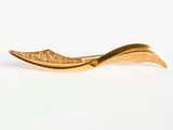a gold plated spoon with a leaf on it