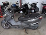 many motorcycles parked in a garage next to each other