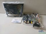 a bag of electronics sitting on a counter next to a computer monitor