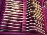 a lot of spoons in a case that are sitting on a table