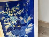 an image of a blue and white painting on a wooden floor