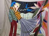 a tapestry of a man and a woman that is hanging on a wall