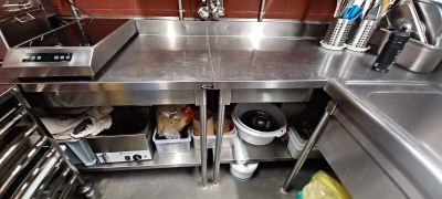 a large stainless steel kitchen with a sink and a stove