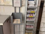 a metal shelf that has a bunch of boxes on it