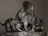 a statue of an elephant and a dog on a rock