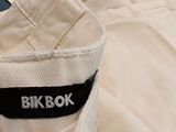 a close up of a pair of white pants with a black label on it