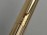 a close up of a gold fountain pen with a black nib