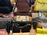 a lot of purses on a table in a store