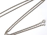 a close up of a chain on a white surface