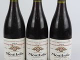 trois bouteilles de vin posées sur une table blanche