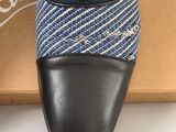 pair of black and blue shoes sitting on top of a box