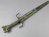 an image of a bronze sword with a dragon head on it