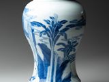 a blue and white vase sitting on a table