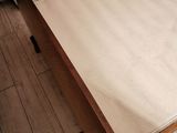 a bed with a wooden frame and a white sheet on top of it