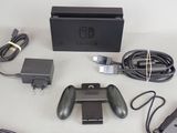 a nintendo wii game system with a controller and charger