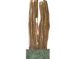sculpture of a couple embracing each other on a green base