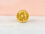 a gold coin sitting on top of a marble counter top