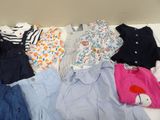 a lot of clothes that are sitting on a table