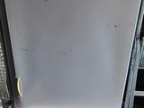 an image of a white refrigerator in a garage