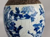 a blue and white vase sitting on a wooden stand