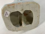 a white vase with a hole in it sitting on a table