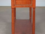 a small wooden table with a marble top and wooden legs