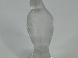 a glass bird that is sitting on top of a table