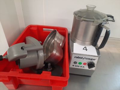 a red container with a blender next to a red container with a silver mixer on it