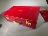 a red suitcase that is sitting on a table