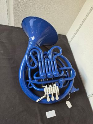 a close up of a blue french horn on a table