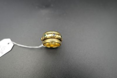 a close up of a ring with a tag on a table